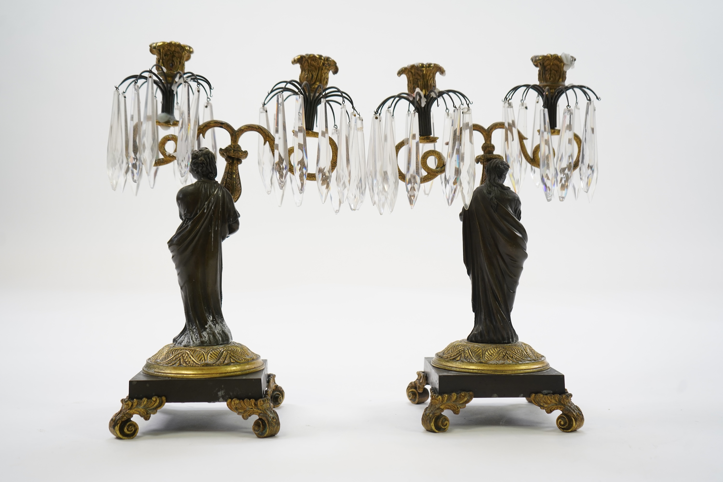 After Mathurin Moreau. A pair of mid 19th century bronze and gilt bronze two branch candelabra